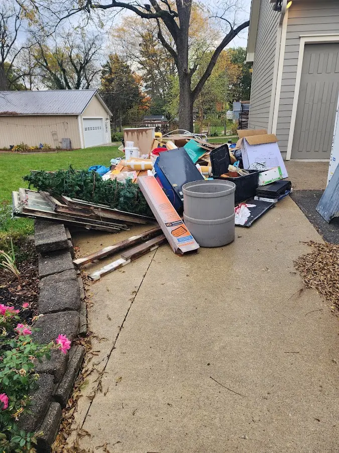 Dumpster being loaded with debris for Estate Cleanout Dumpster Rental in Hapeville